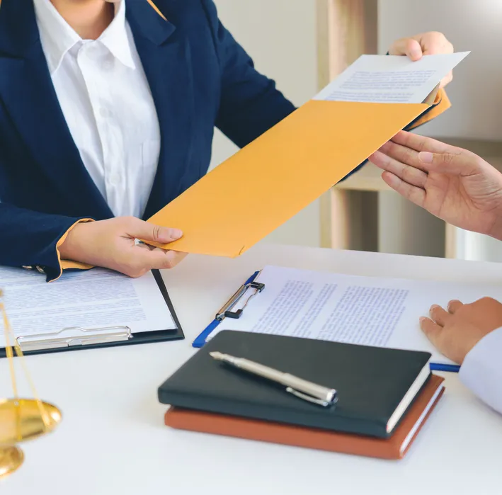 Personal injury attorney explaining claim paperwork to a client in New York