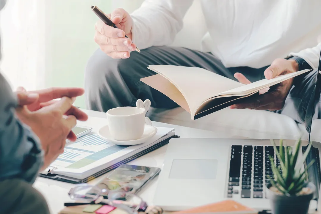Two people reviewing documents during a legal consultation, representing the Personal Injury Lawyer FAQ at Burdzy & Associates in New York.