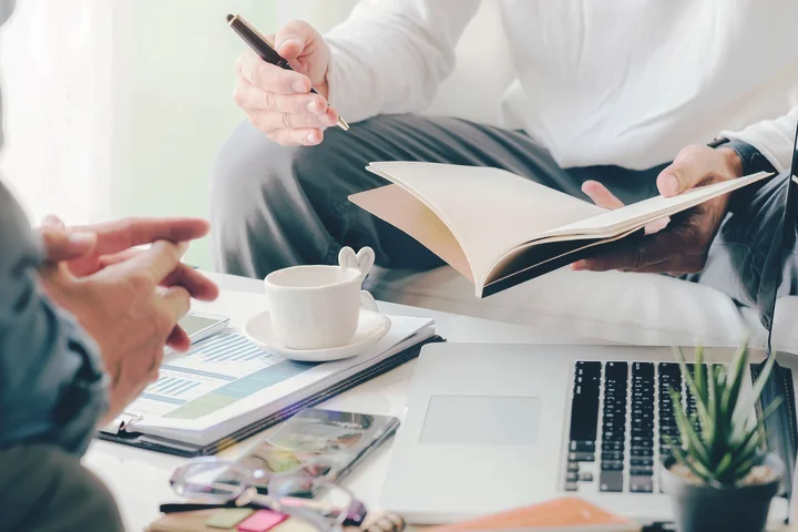 Lawyer meeting with client, reviewing documents and notes in a New York office