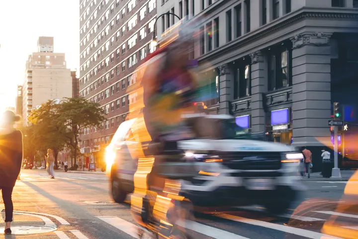 NYC street at sunset with cyclist and traffic, vehicle accident claims in New York