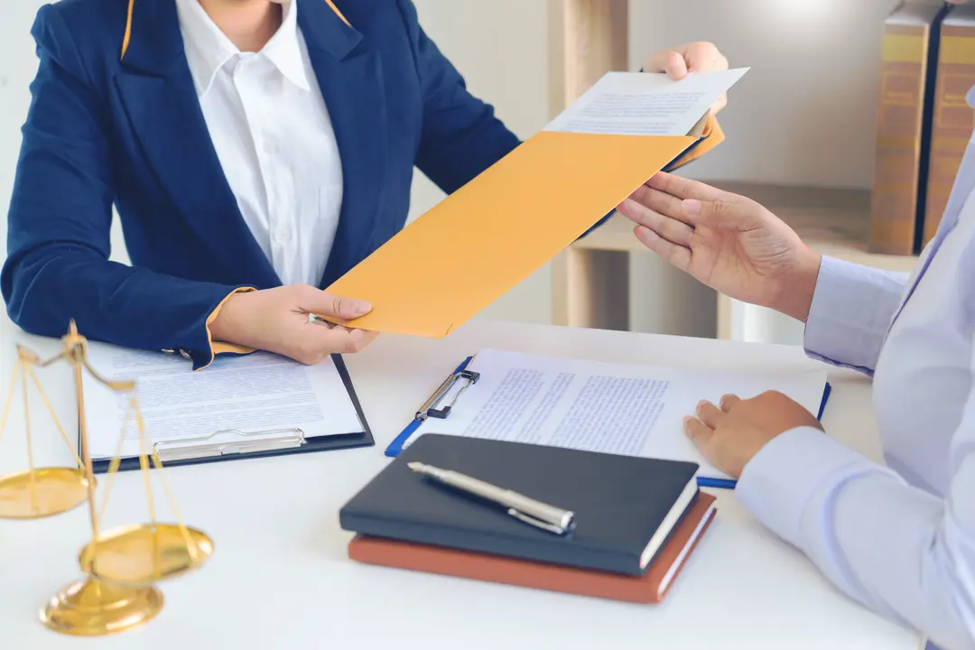 Personal injury attorney explaining claim paperwork to a client in New York